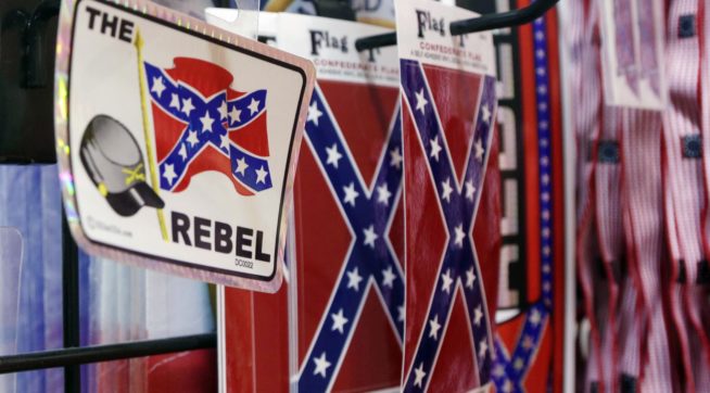 Confederate flag-themed stickers are displayed at Arkansas Flag and Banner in Little Rock, Ark., Tuesday, June 23, 2015. Major retailers including Amazon, Sears, eBay and Etsy and Wal-Mart Stores Inc., are halting sales of the Confederate flag and related merchandise. (AP Photo/Danny Johnston)